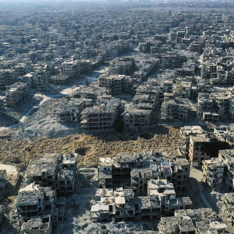 An aerial picture shows a view the destruction at the Yarmouk camp for Palestinian refugees and its cemetery, in the south of Damascus on December 14, 2024. Islamist-led rebels took Damascus in a lightning offensive on December 8, ousting president Bashar al-Assad and ending five decades of Baath rule in Syria. (Photo by Aris MESSINIS / AFP) (Photo by ARIS MESSINIS/AFP via Getty Images)