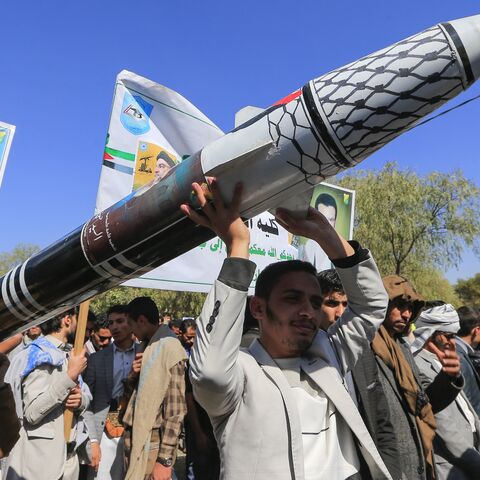 Men carry a mock missile during a rally by university students and faculty denouncing strikes on Yemen and in solidarity with Palestinians.