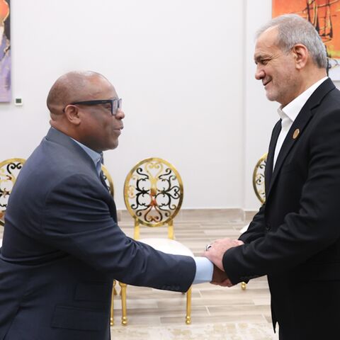 Iranian President Masoud Pezeshkian (R) shakes hands with D-8 Secretary General Isiaka Abdulqadir Imam, Cairo, Dec. 19, 2024.