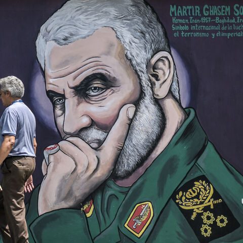 A man walks past a mural depicting slain commander of the IRGC's Quds Force Qasem Soleimani in Caracas on April 26, 2024. (Photo by Juan BARRETO / AFP) (Photo by JUAN BARRETO/AFP via Getty Images)