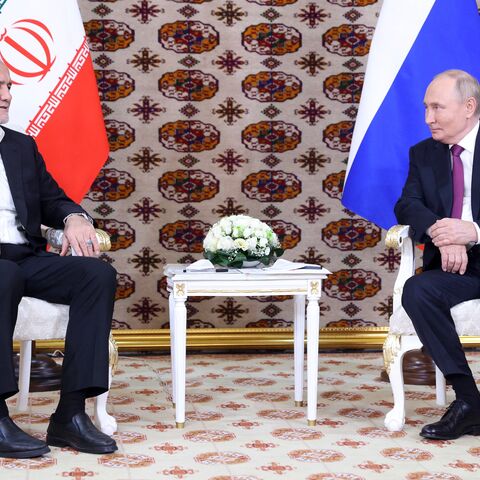 In this pool photograph distributed by the Russian state agency Sputnik, Russia's President Vladimir Putin meets with Iran's President Masoud Pezeshkian on the sidelines of an international forum "Interrelation of times and civilizations - basis of peace and development" in Ashgabat on Oct. 11, 2024. 