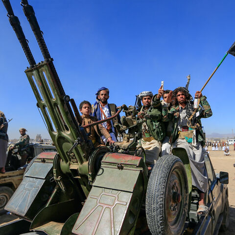 Armed Yemeni tribesmen join Houthi fighters riding military vehicles during an anti-US and Israel rally on the outskirts of the Houthi-controlled capital Sanaa on Jan. 16, 2025. 