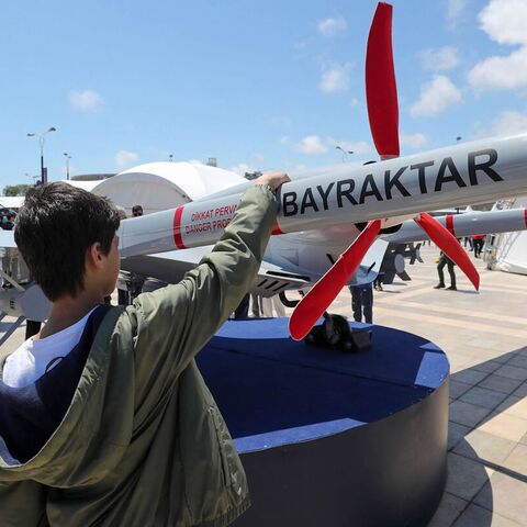 A young man looks at the Bayraktar TB2 drone.