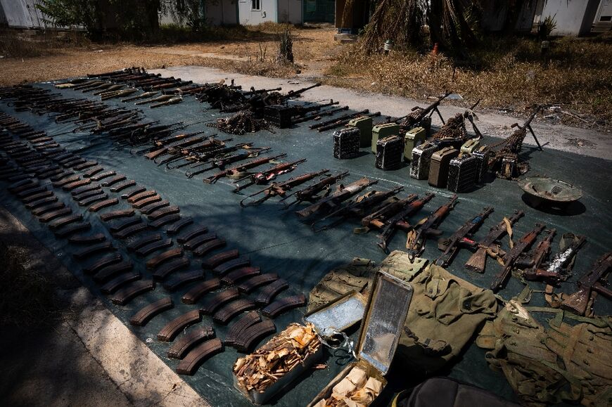 Weapons confiscated from the insurgents are displayed by Rwandan troops in Mocimboa da Praia last September