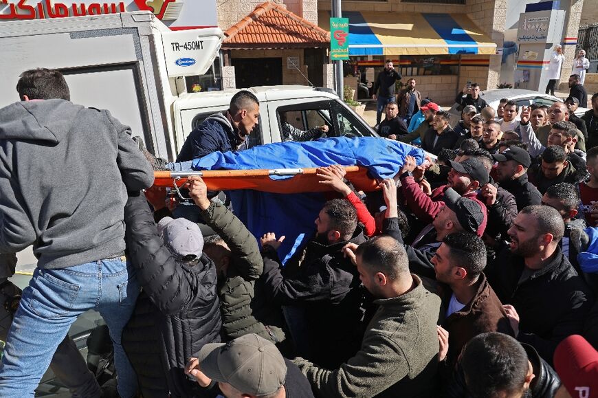 Palestinians carry the body of a man, one of three killed by Israeli forces in the occupied West Bank city of Nablus