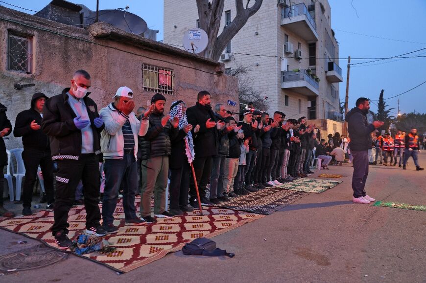 Palestinians perform the maghreb (sunset) before being joined by demonstrators who numbered in the hundreds