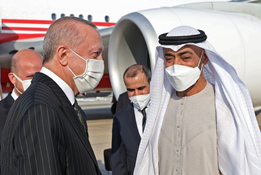 Turkish President Recep Tayyip Erdogan (L) welcomed by Abu Dhabi Federal Minister Thani bin Ahmed Al-Zeyoudi (R) at Abu Dhabi International Airport, in a picture released by the office of Turkey's president