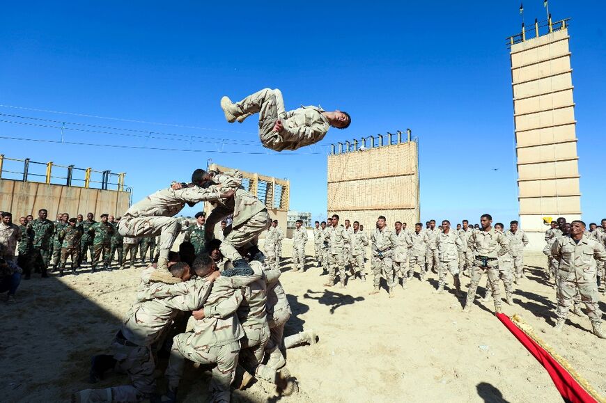 Cadets of the special forces of the self-styled Libyan National Army affiliated with eastern strongman Khalifa Haftar take part in a graduation ceremony in the eastern city of Benghazi, on January 20, 2022