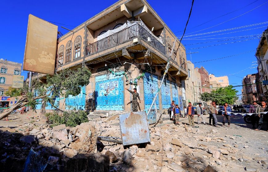 Yemenis inspect damage following a reported overnight air strike by the Saudi-led coalition on the Huthi-held capital Sanaa, on December 24, 2021