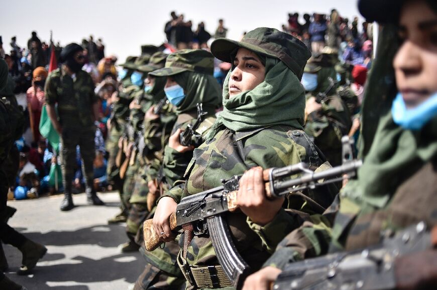 Sahrawi women soldiers parade on the 45th anniversary of the proclamation of the Sahrawi Arab Democratic Republic by the Polisario Front, at a refugee camp near the southwestern Algerian city of Tindouf, on February 27, 2021