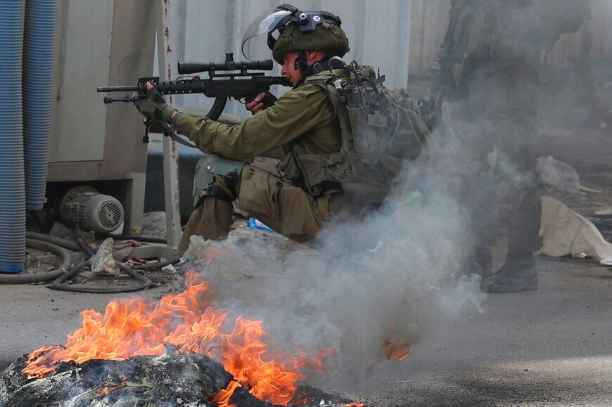 An Israeli soldier is seen during clashes with Palestinian in village of Azzun in the north of the occupied West Bank