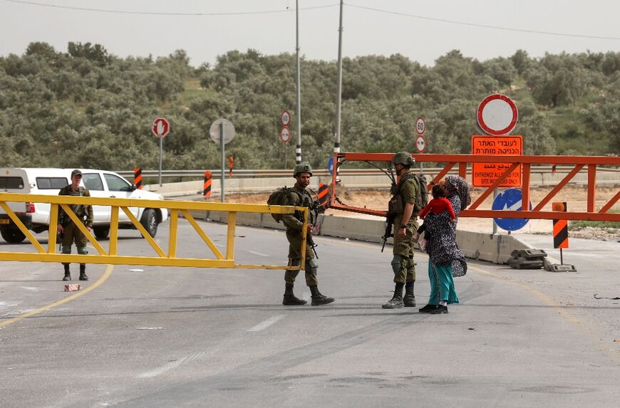 Israeli security forces close-off the entrance to Azzun village, in the north of the occupied West Bank, during an army operation early on April 30, 2022