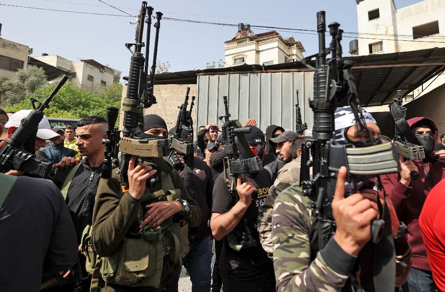 Palestinian gunmen take part in the funeral of Muhammad Zakarneh, 17, who died of injuries sustained a day earlier during a raid by Israeli soldiers, in Jenin in the occupied West Bank, on April 11, 2022 