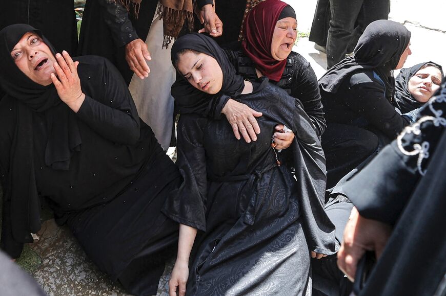 The sister of Ahmed al-Saadi who was killed during an Israeli army raid on Jenin faints during his funeral