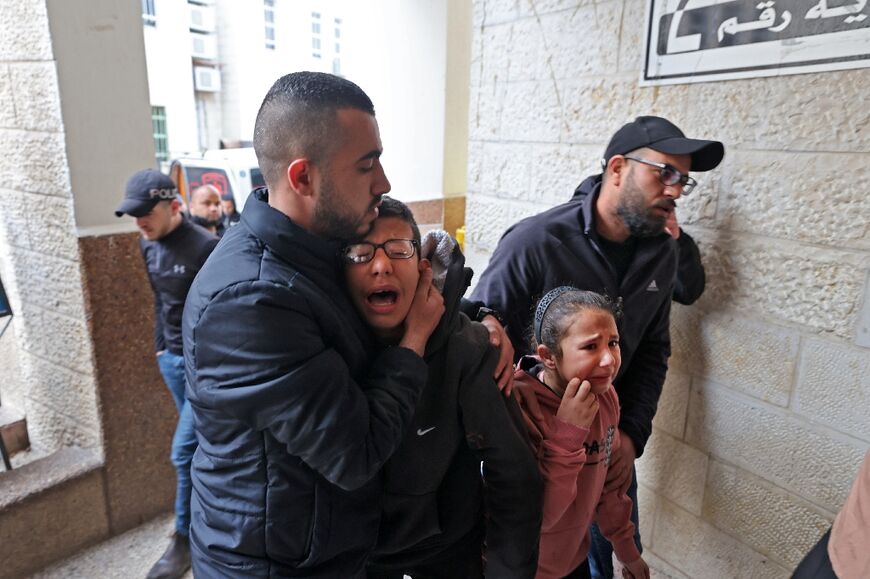 Palestinians at a hospital in Jenin, the occupied West Bank, react following the death of Muhammad Zakarneh, 17, of injuries sustained a day earlier during a raid by Israeli soldiers