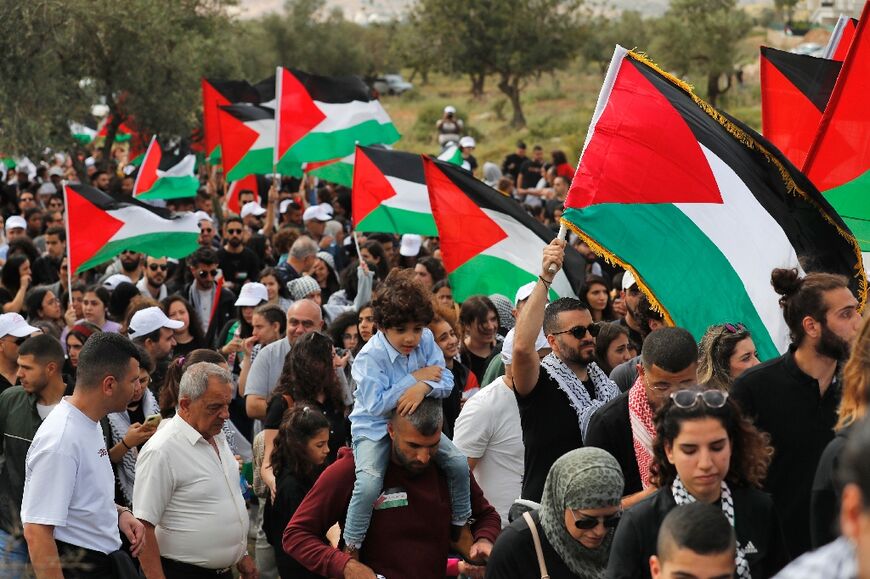 Arab Israeli protesters hold up Palestinian national flags during a demonstration near the city of Sakhnin in northern Israel ahead of Palestinian's marking of the Nakba, the "catastrophe" of Israel's creation in 1948