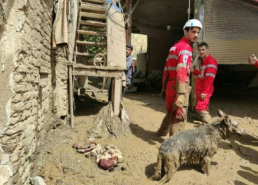Iranian Red Crescent members at work in Emamzadeh Davoud village west of Tehran after a deadly landslide caused by floods