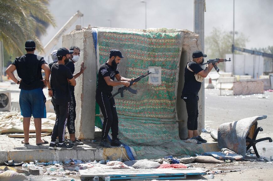 Armed members of Saraya al-Salam (Peace Brigade), the military wing affiliated with Shiite cleric Moqtada al-Sadr, are pictured during clashes with Iraqi security forces in Baghdad's Green Zone