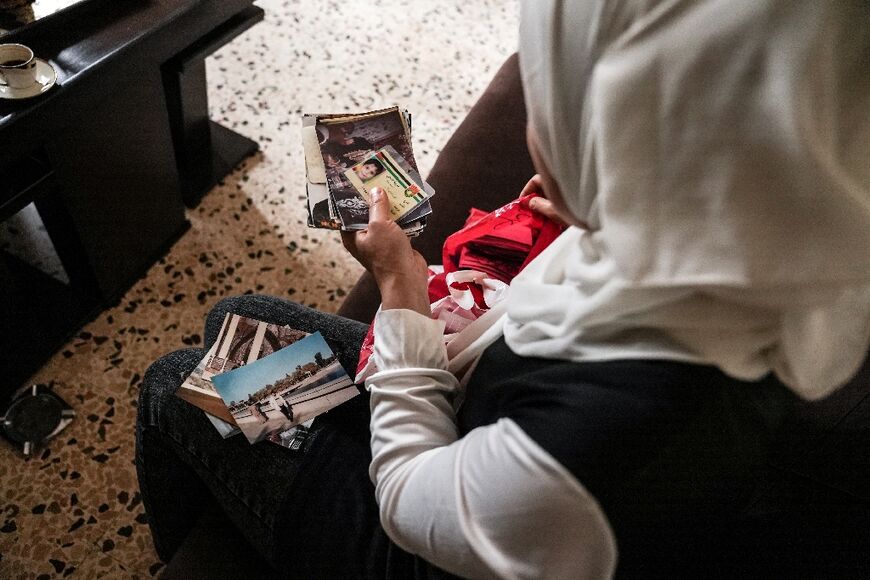 Sous inspects her family documents at her apartment in Lebanon's Bekaa Valley
