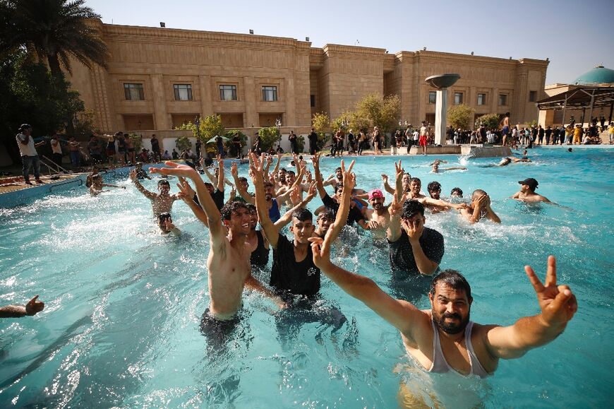 Supporters of Iraqi Shiite cleric Moqtada Sadr swim in the pool at the Republican Palace after storming the government headquarters  on Monday
