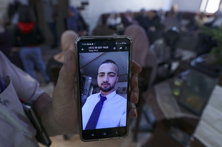 A relative shows a picture on his mobile phone of Palestinian Mohammed al-Shaham, 21, who was killed during an Israeli raid