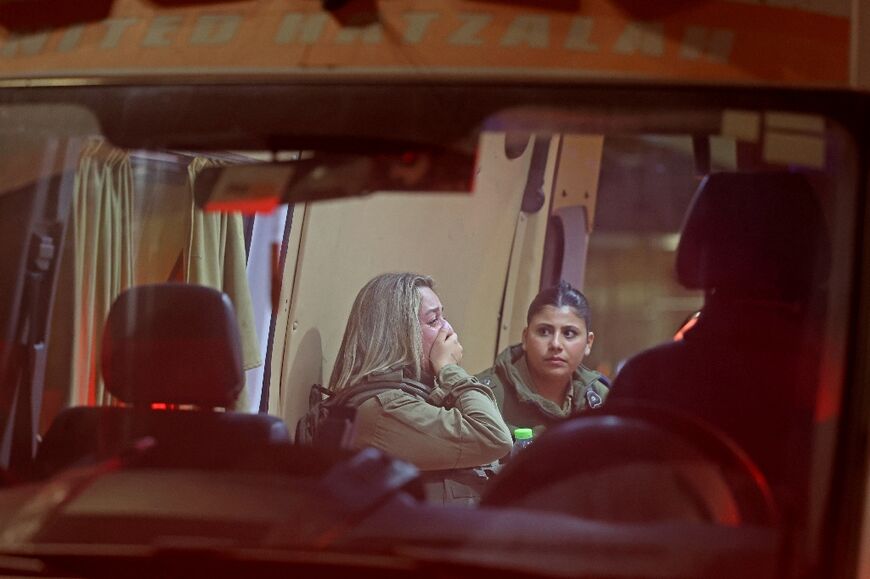 An Israeli border policewoman reacts inside an ambulance following a shooting attack at a checkpoint near the Shuafat refugee camp in Israeli-annexed east Jerusalem