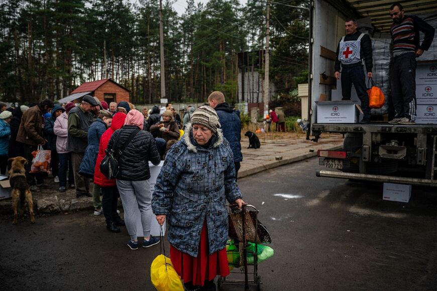 Local residents wait in line to receive food and humanitarian aid in recently liberated Svyatohirs'k in Ukraine's Donetsk region
