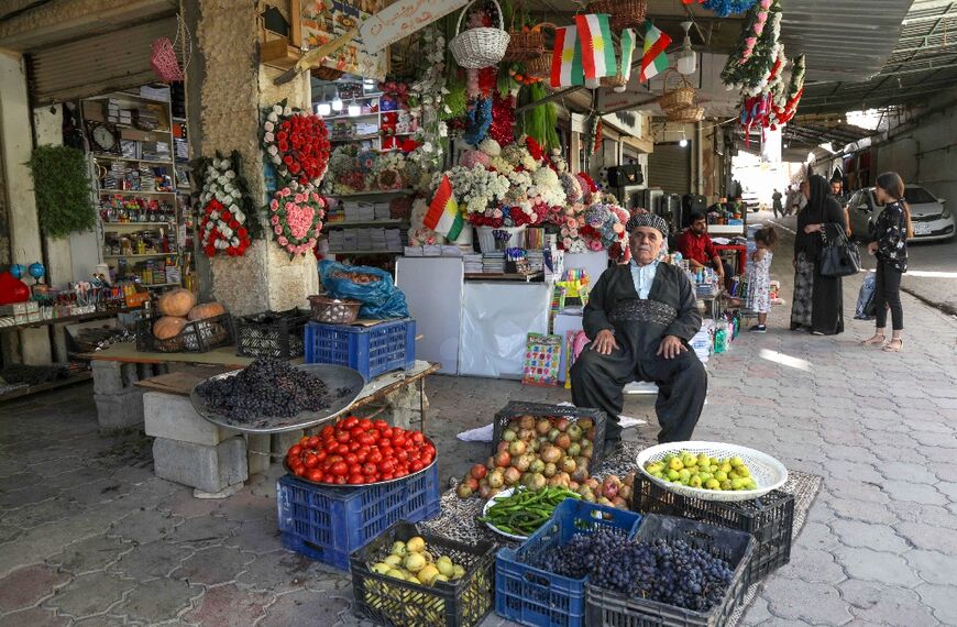 A Kurdish vendor tends to his shop at a market in the town of Koye in the autonomous Kurdish region of northern Iraq