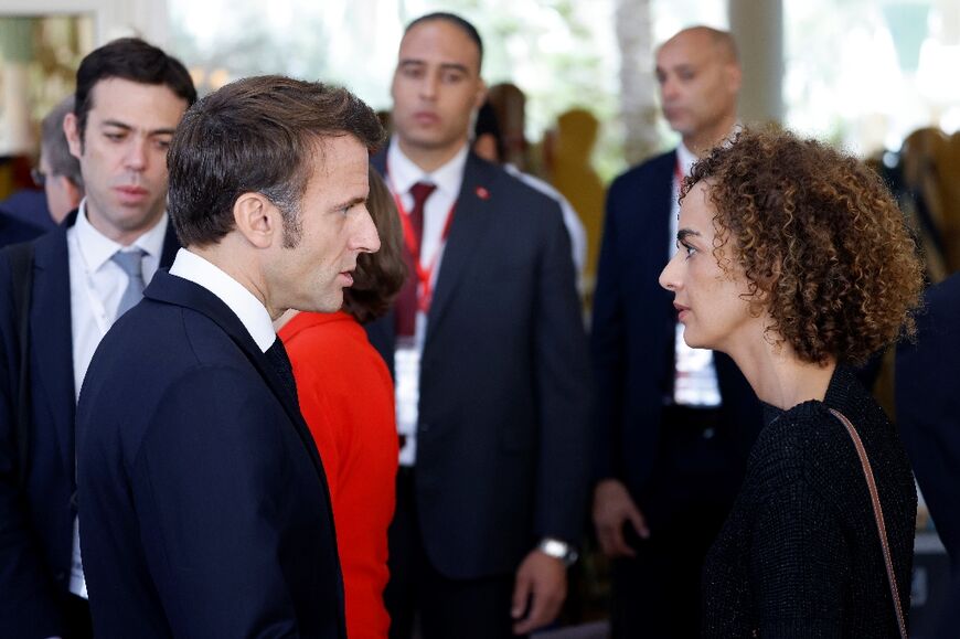 French President Emmanuel Macron (L) speaks with his personal representative to the 
International Organisation of Francophonie, Franco-Moroccan writer Leila Slimani (R), in Djerba, Tunisia