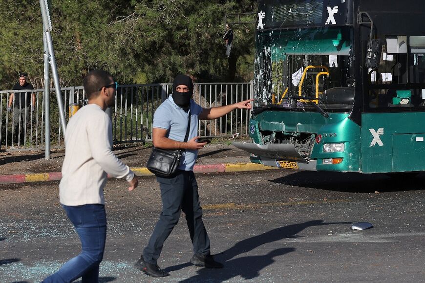 Israeli security forces check the scene of an explosion at a bus stop in Jerusalem on November 23, 2022. At least one person was killed and 14 wounded in two separate explosions 