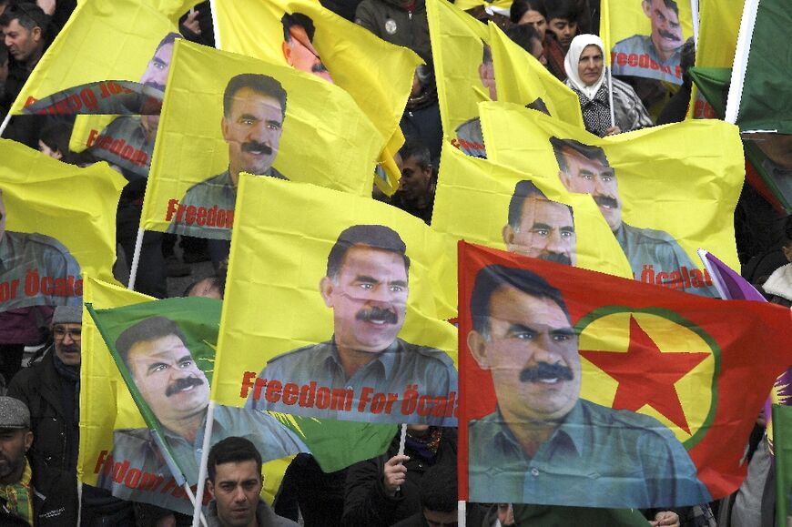 Kurds wave flags with the image of convicted Kurdistan Worker's Party (PKK) leader Abdullah Ocalan during a demonstration in France in 2000