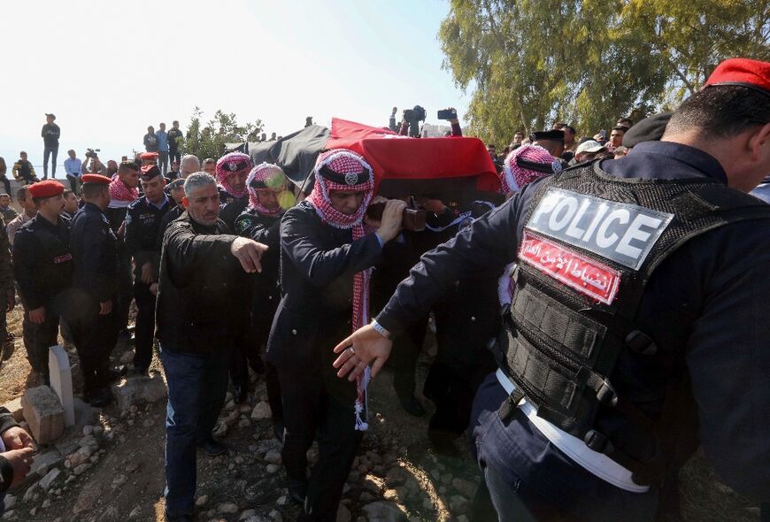 Jordanian security personnel carry the coffin of Colonel Abdul Razzaq Dalabeh during the funeral after he was shot dead during protests