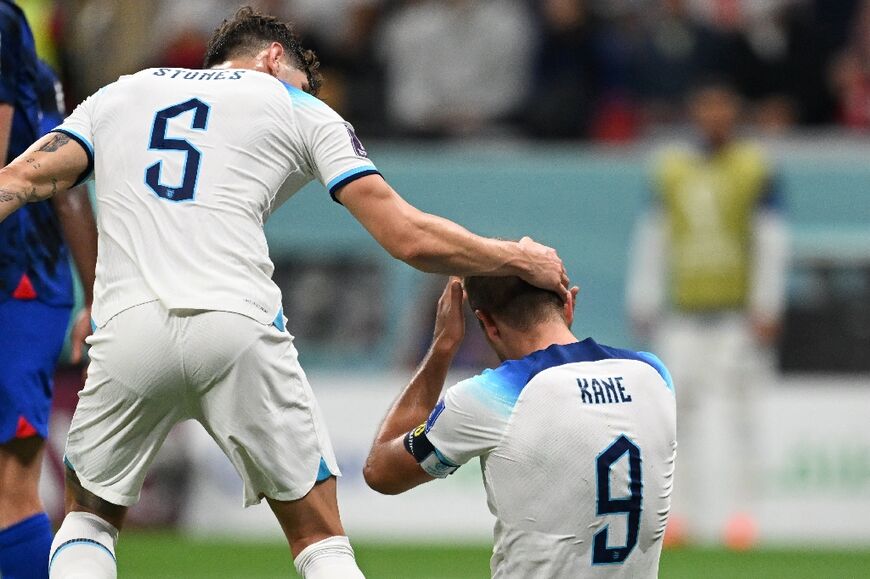 Harry Kane is consoled by teammate John Stones after he missed a penalty that would have brought England level against France