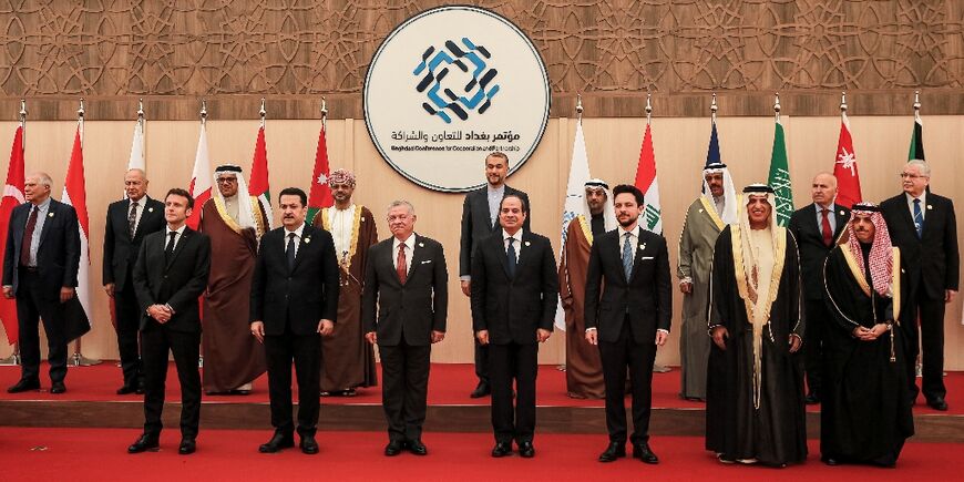 French President Emmanuel Macron stands alongside Iraq's Prime Minister Mohamed Shia al-Sudani and Jordan's King Abdullah among others at the summit