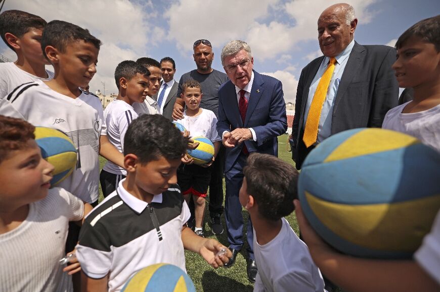 Jibril Rajoub, who is president of the Palestinian Olympic Committee, with Thomas Bach, president of the International Olympic Committee, meeting young football players in the West Bank city of Al-Ram on September 19, 2022
