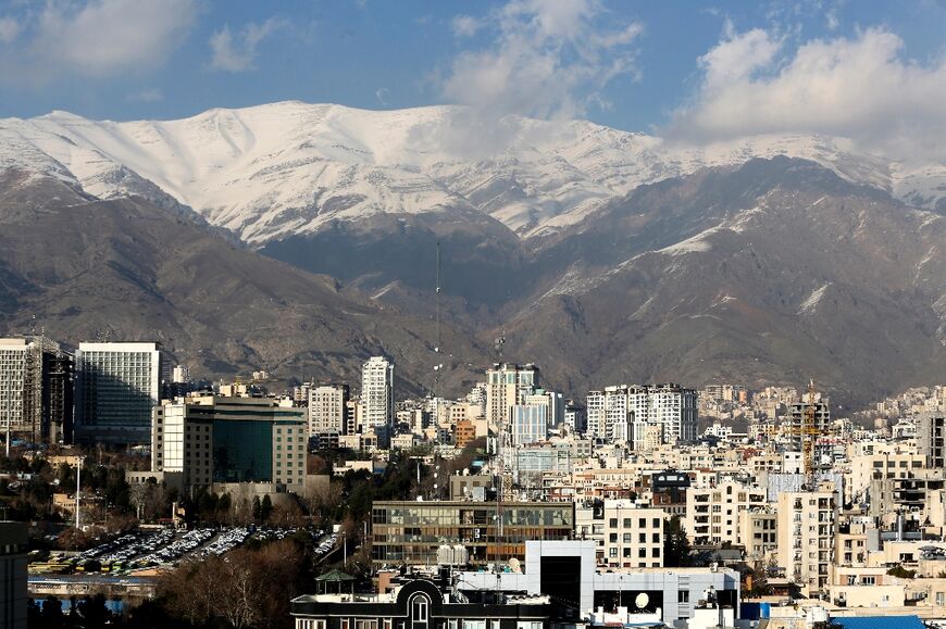 The Iranian capital Tehran with the snow-covered Alborz mountain range in the background, on January 7, 2023