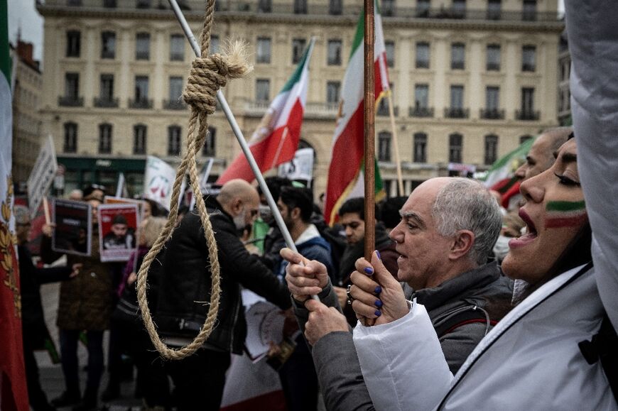 A protestor holds a gallows rope during a rally in Lyon on January 8, 2023 against the Iranian regime