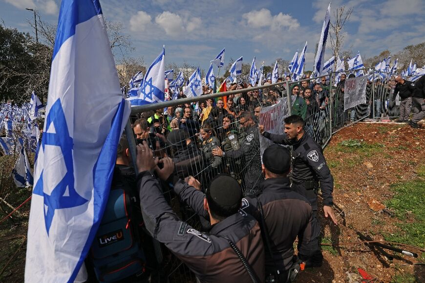 Israeli security forces reinforce fencing during a rally outside the Knesset in Jerusalem against controversial legal reforms by the country's hard-right government
