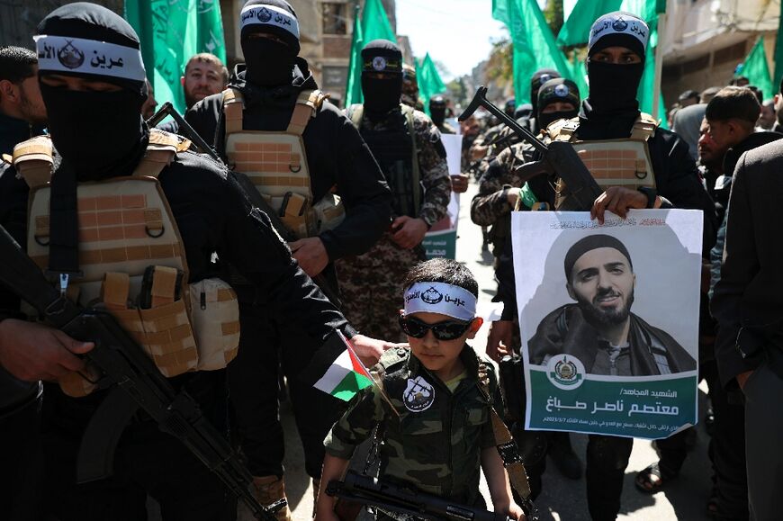 Hamas militants rally in Gaza to denounce the killing of Palestinians by the Israeli army in the West Bank