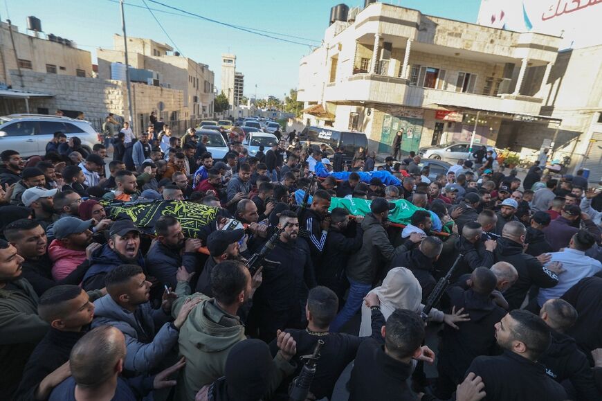 Masked, heavily armed men fired into the air as they paraded through Jenin's streets for the funerals of the four dead