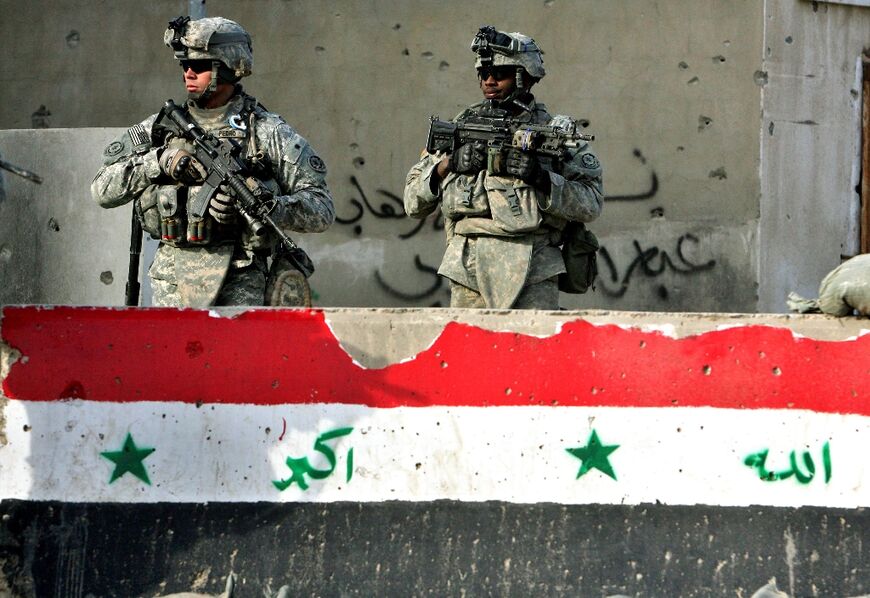 US soldiers from the 2nd Squadron, 2nd Stryker Cavalry Regiment behind a concrete block painted with an Iraqi flag in Baghdad, in the file photo from January 18, 2008