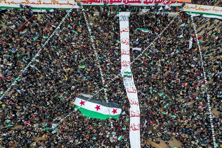 Demonstrators carried a giant Syrian opposition flag during the rally to mark 12 years since the start of the uprising 