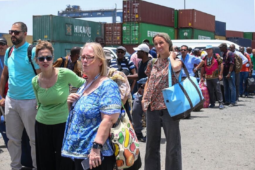 Foreigners desperate to escape the violence in Sudan queue to board an evacuation ship in Port Sudan on the Red Sea coast