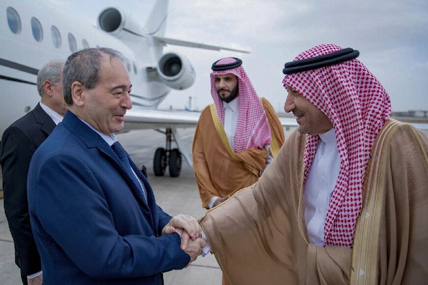 Saudi Deputy Foreign Minister Waleed al-Khuraiji (R) receiving Syrian Foreign Minister Faisal Mekdad (L) on his arrival in Jeddah