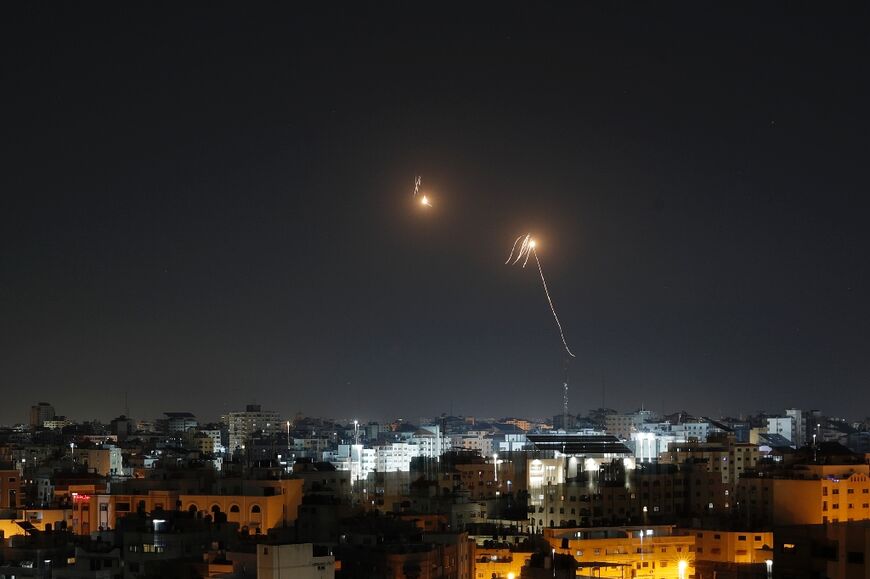 Streaks of light are seen in the sky as Israeli air defences intercept rocket fire from the Gaza Strip