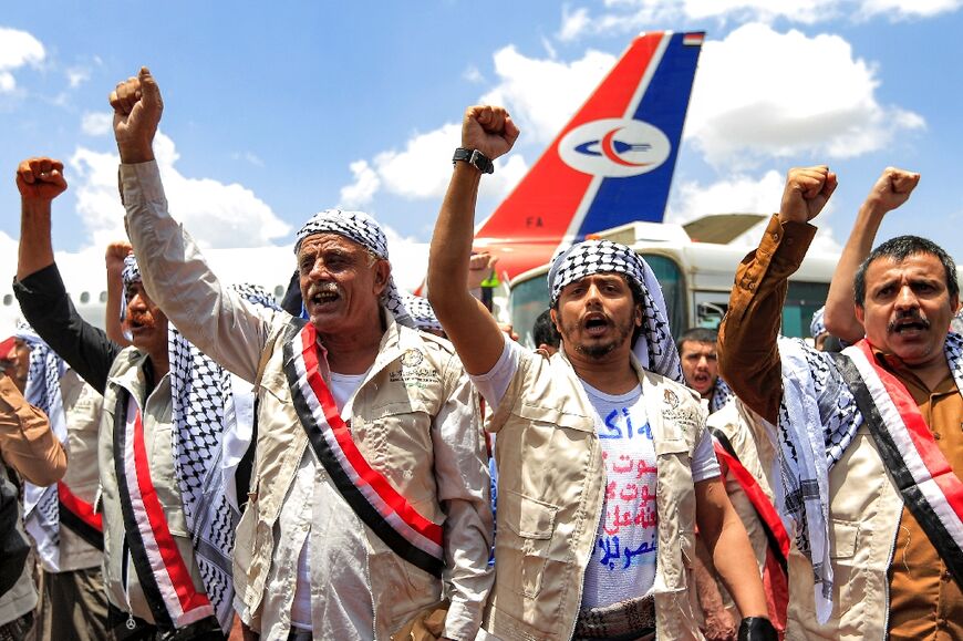 Returning Huthi rebels raised fists as they landed in Sanaa in a prisoner exchange 