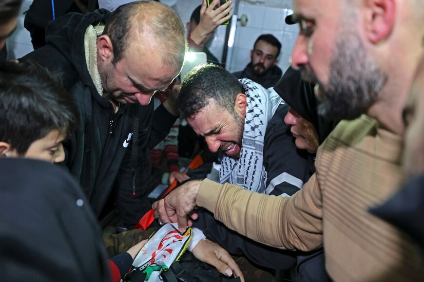 Relatives mourn during the funeral of Palestinian Mohammed Abu Bakr, killed during the Isaeli raid in Nablus 