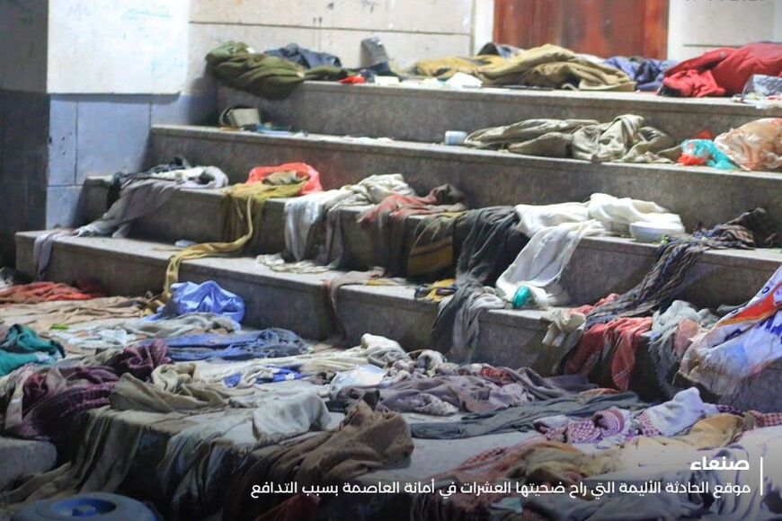 Clothes are strewn at the scene of the stampede on the steps of a charity distribution centre in Sanaa