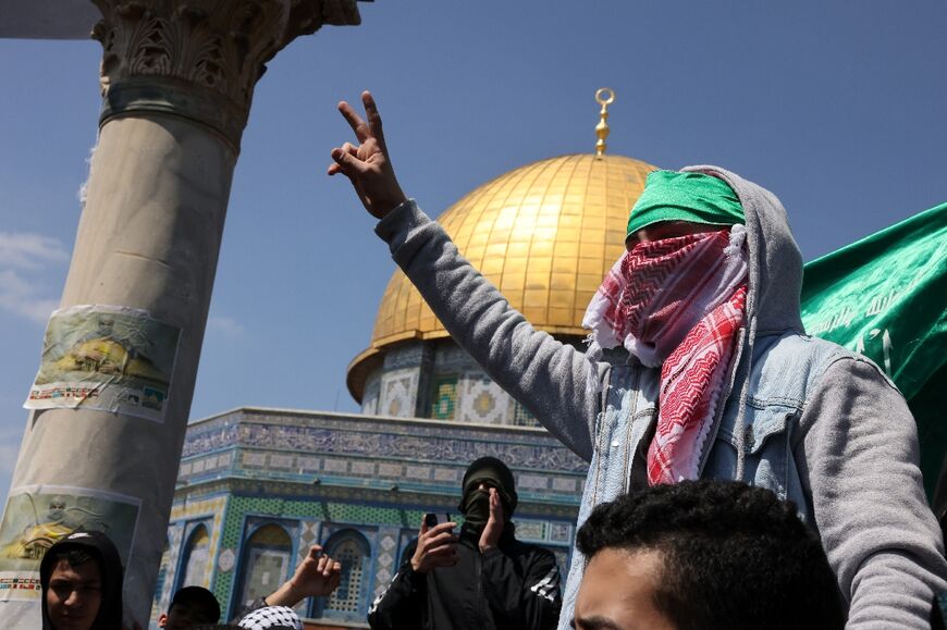 A youth flashes the victory sign at Jerusalem's Al-Aqsa mosque compound following Friday prayers 