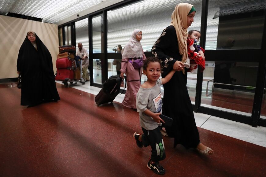 People evacuated from Sudan arrive at Baghdad International Airport on April 27, 2023 